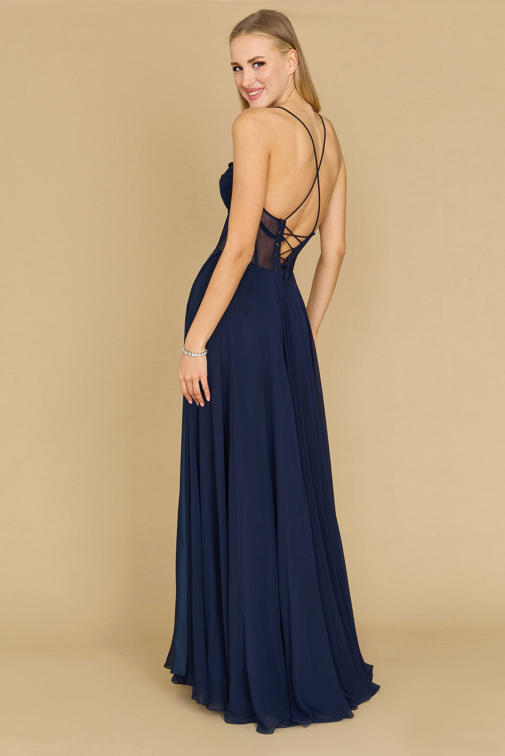 A stunning long chiffon corset formal prom dress in navy, featuring a fitted bodice with intricate detailing and a flowing skirt that cascades elegantly to the floor.