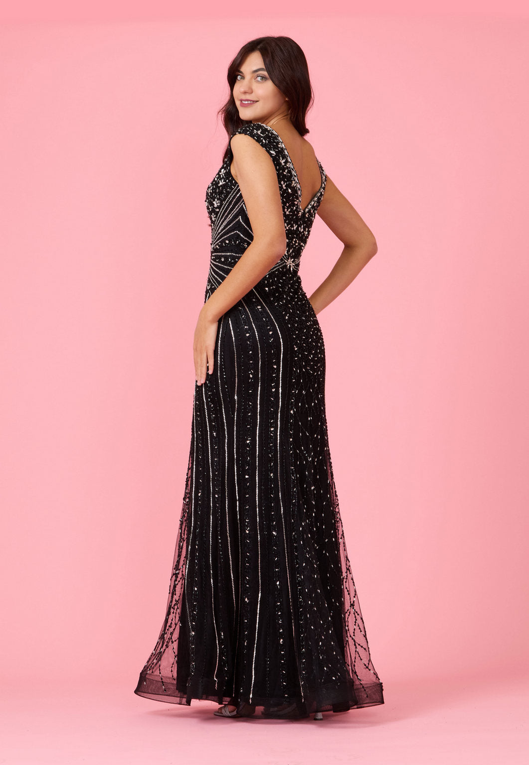 A stunning long hand beaded couture formal evening dress featuring intricate beadwork and a flowing silhouette, perfect for elegant occasions.