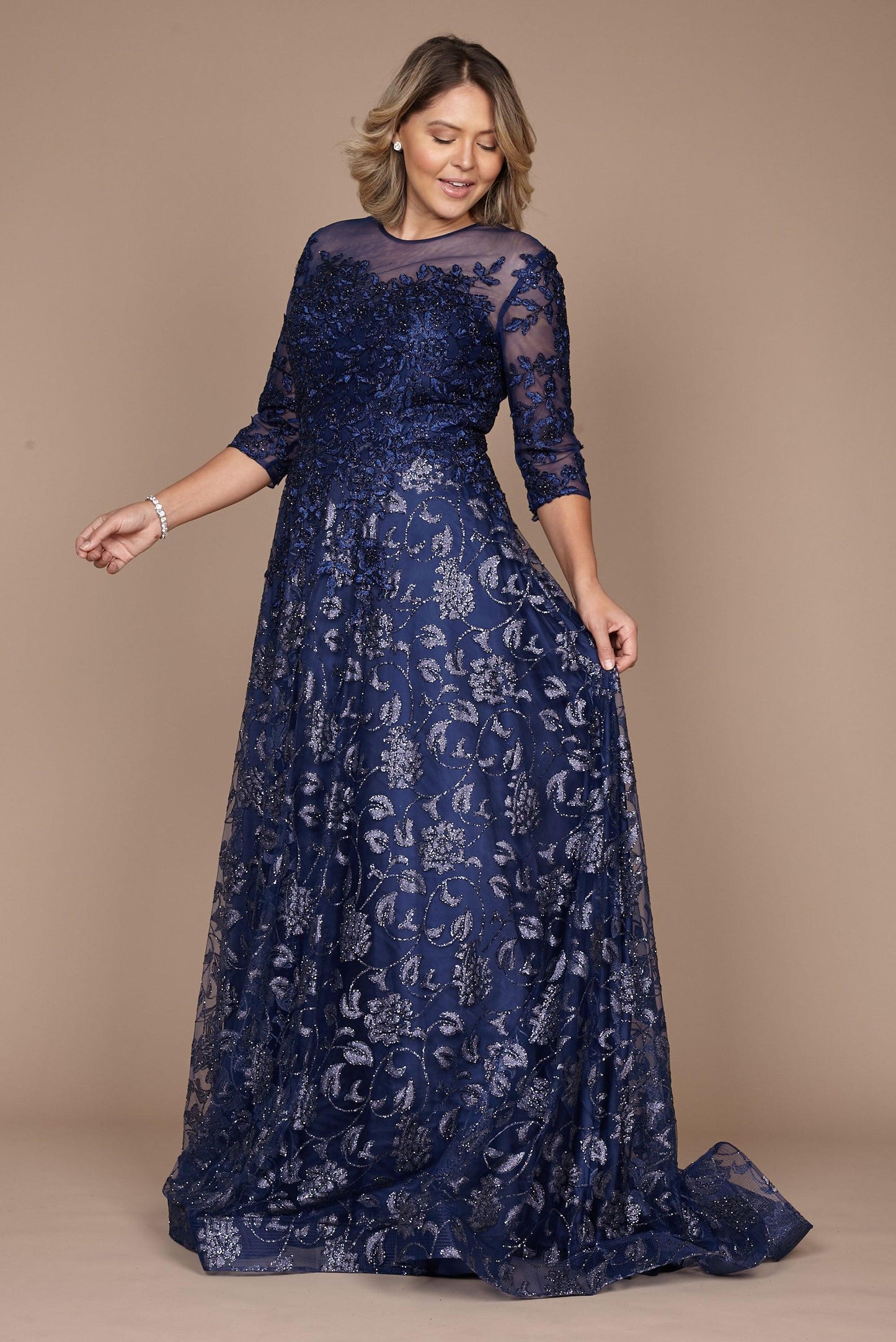 A stunning long formal lace evening dress in navy, featuring intricate lace detailing and a flowing silhouette, perfect for elegant occasions.