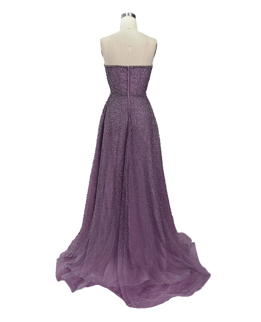 A stunning long strapless formal couture dress adorned with intricate hand-beaded details, showcasing elegance and sophistication.
