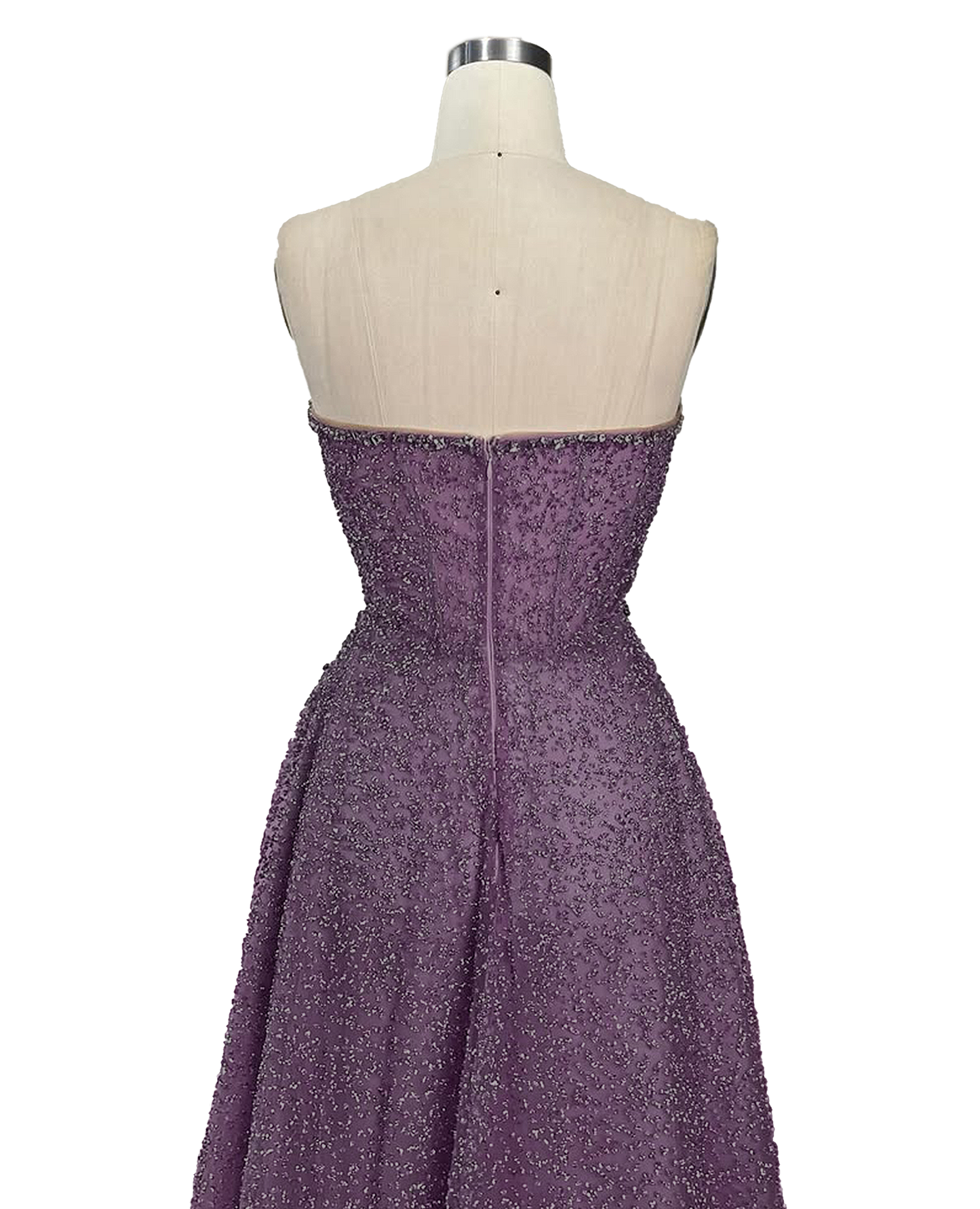 A stunning long strapless formal couture dress adorned with intricate hand-beaded details, showcasing elegance and sophistication.