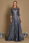 A long formal evening dress in charcoal gray, featuring intricate lace detailing and a flowing silhouette, elegantly draping to the floor.