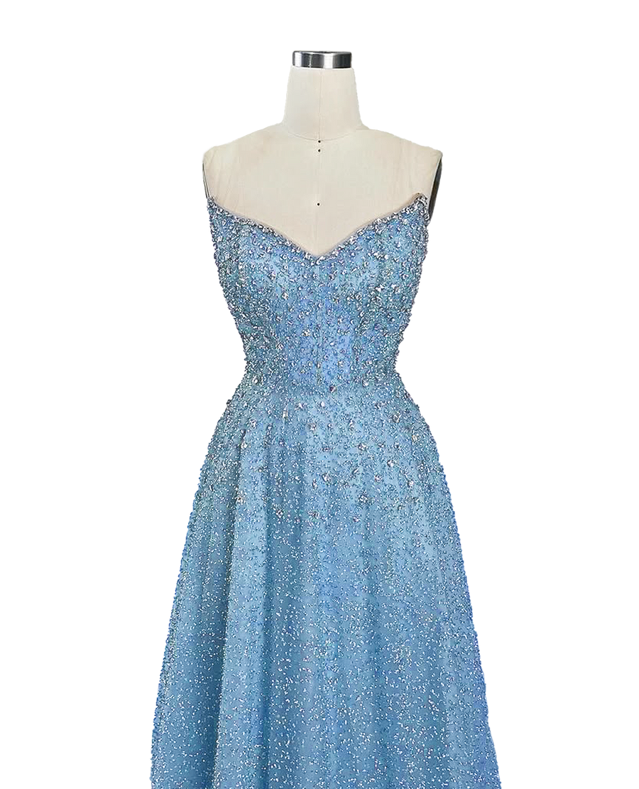 A stunning long strapless formal couture dress adorned with intricate hand-beaded details, showcasing elegance and sophistication.