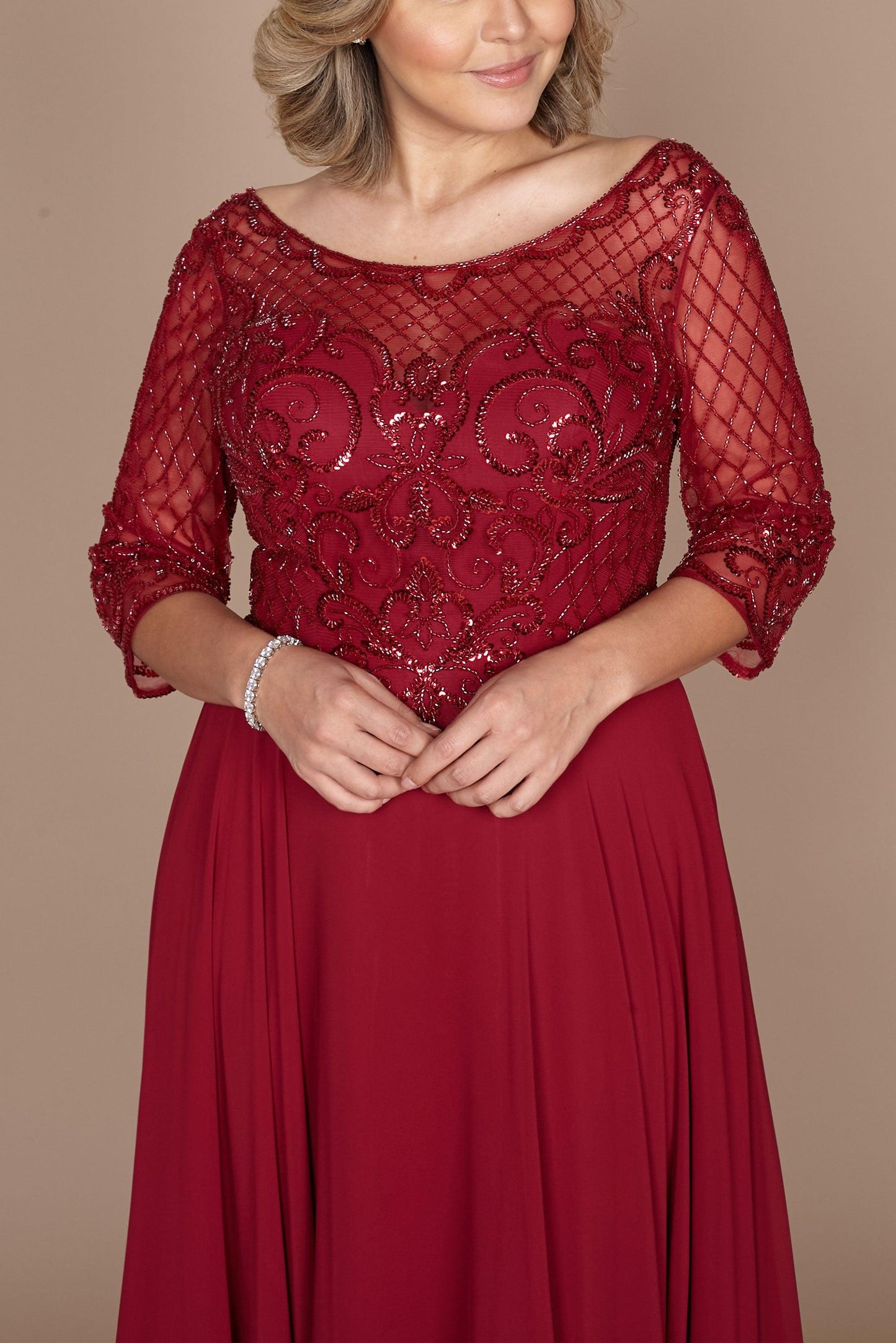 Elegant long sleeve mother of the bride dress in rich burgundy, adorned with intricate hand-beaded detailing, showcasing a sophisticated silhouette perfect for a formal wedding.